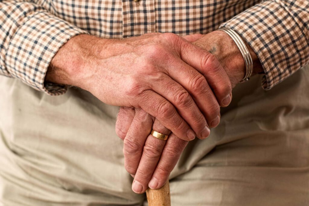 older man with walking stick