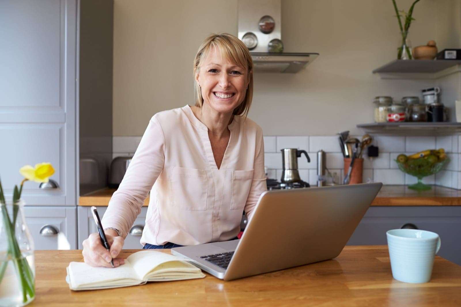 woman with laptop and notepad