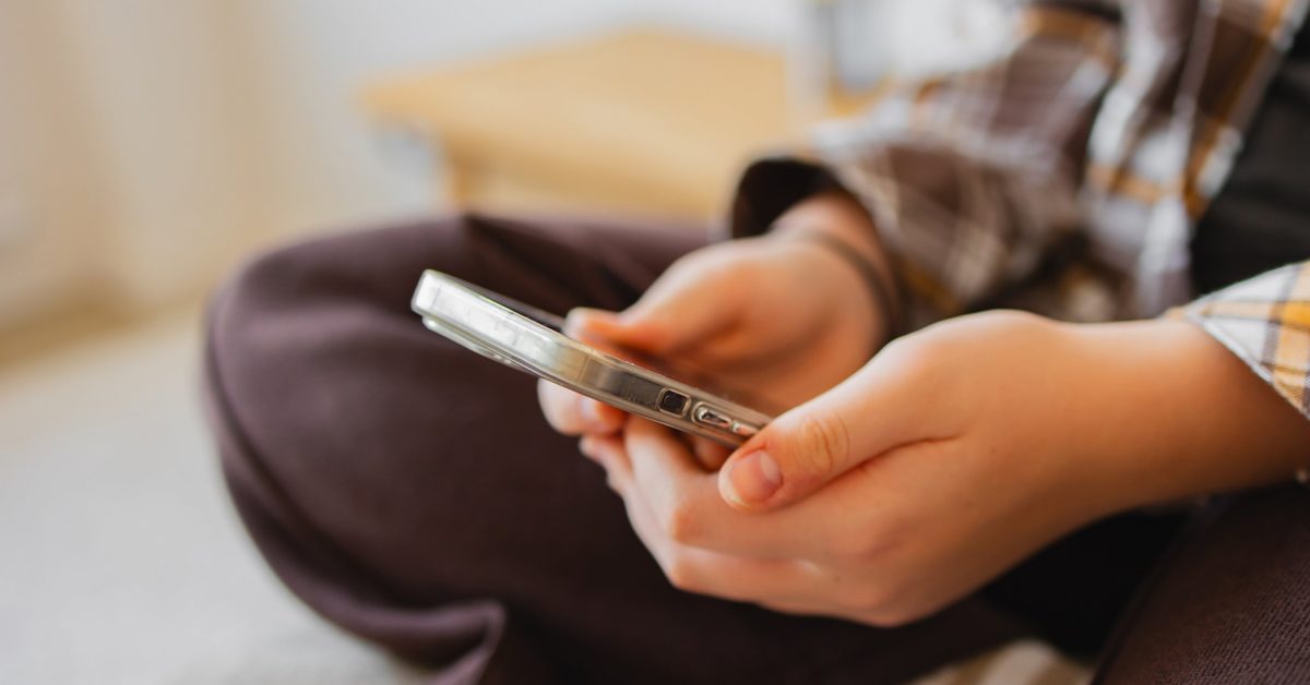 Child using a smartphone - UK social media ban for under-16s